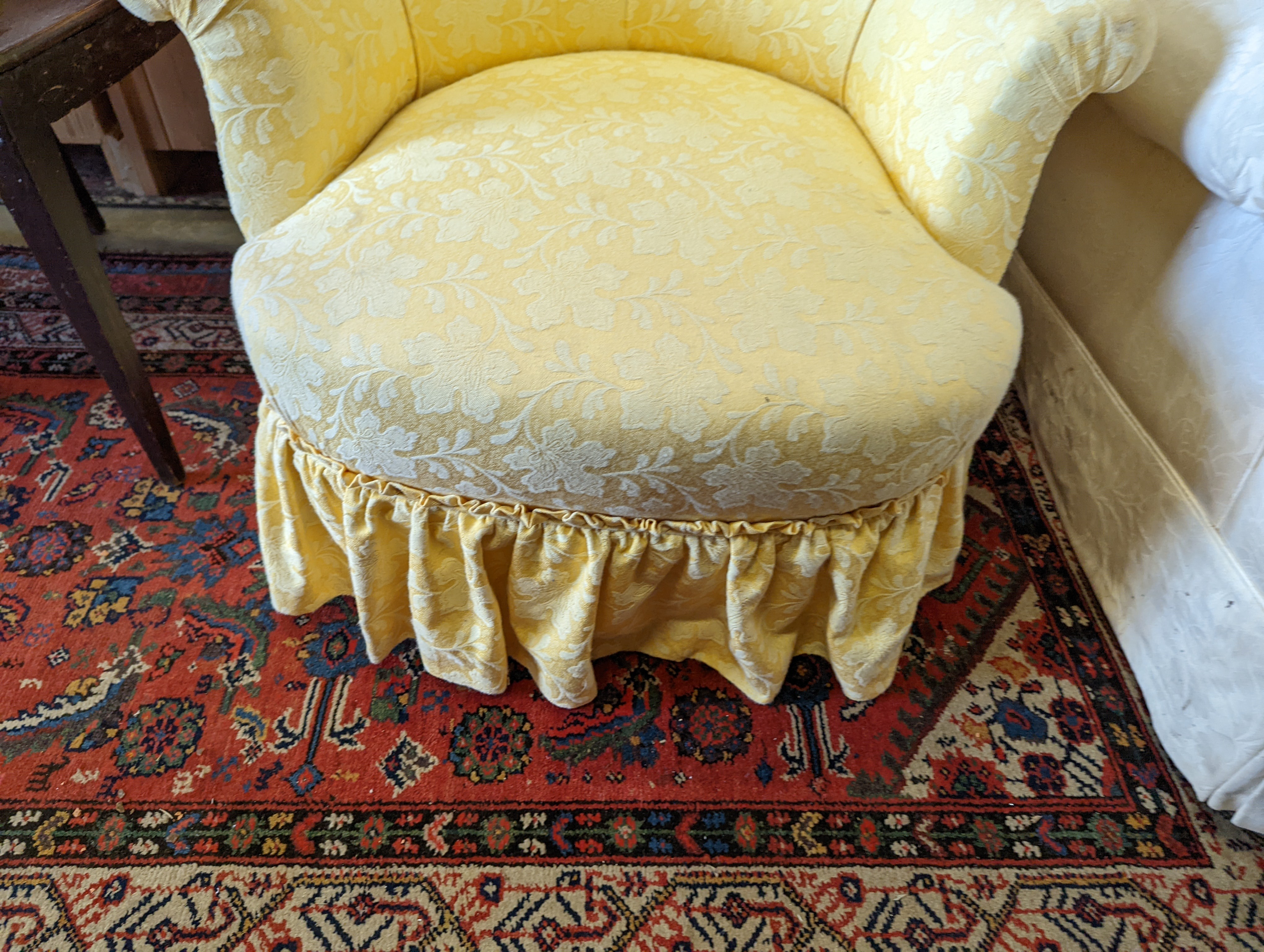 A brown leather upholstered desk chair, a mahogany hall chair and two upholstered armchairs
